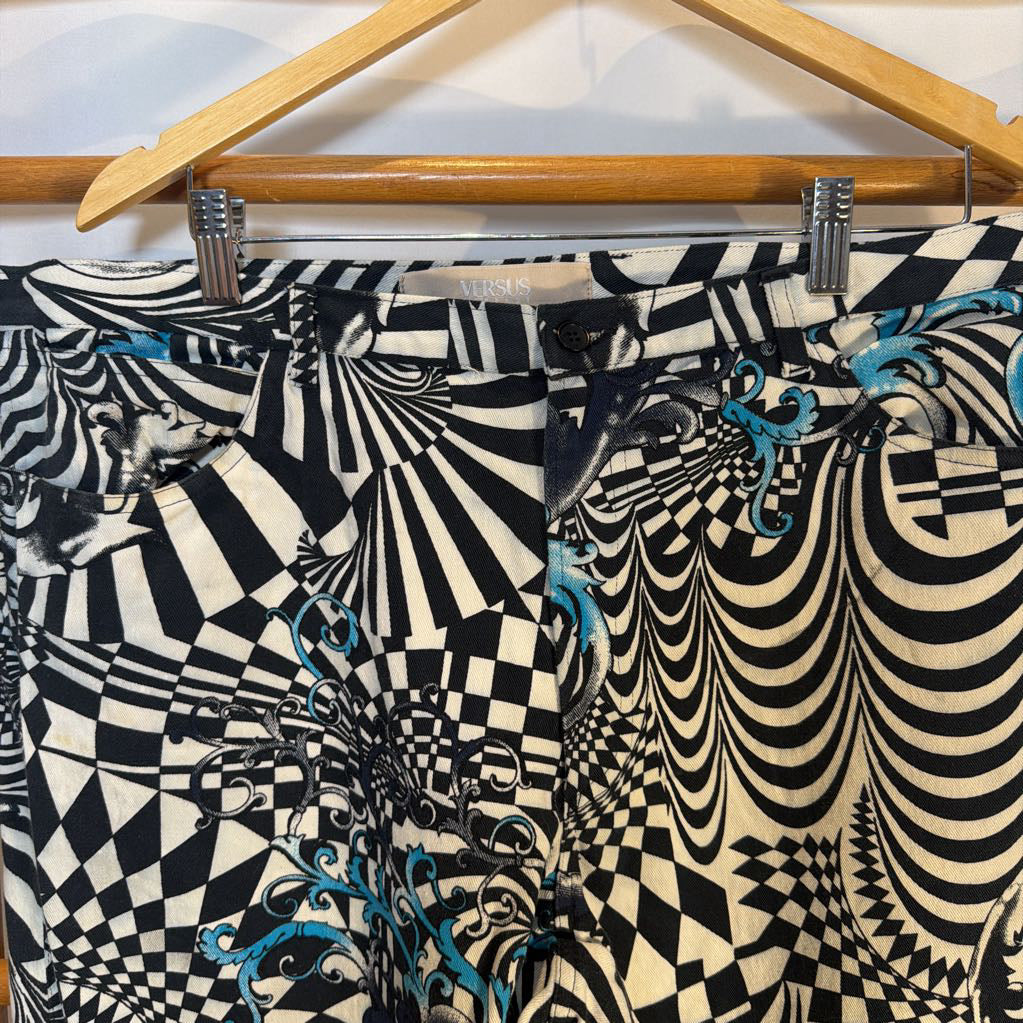 Black and white patterned pants with blue accents on a hanger