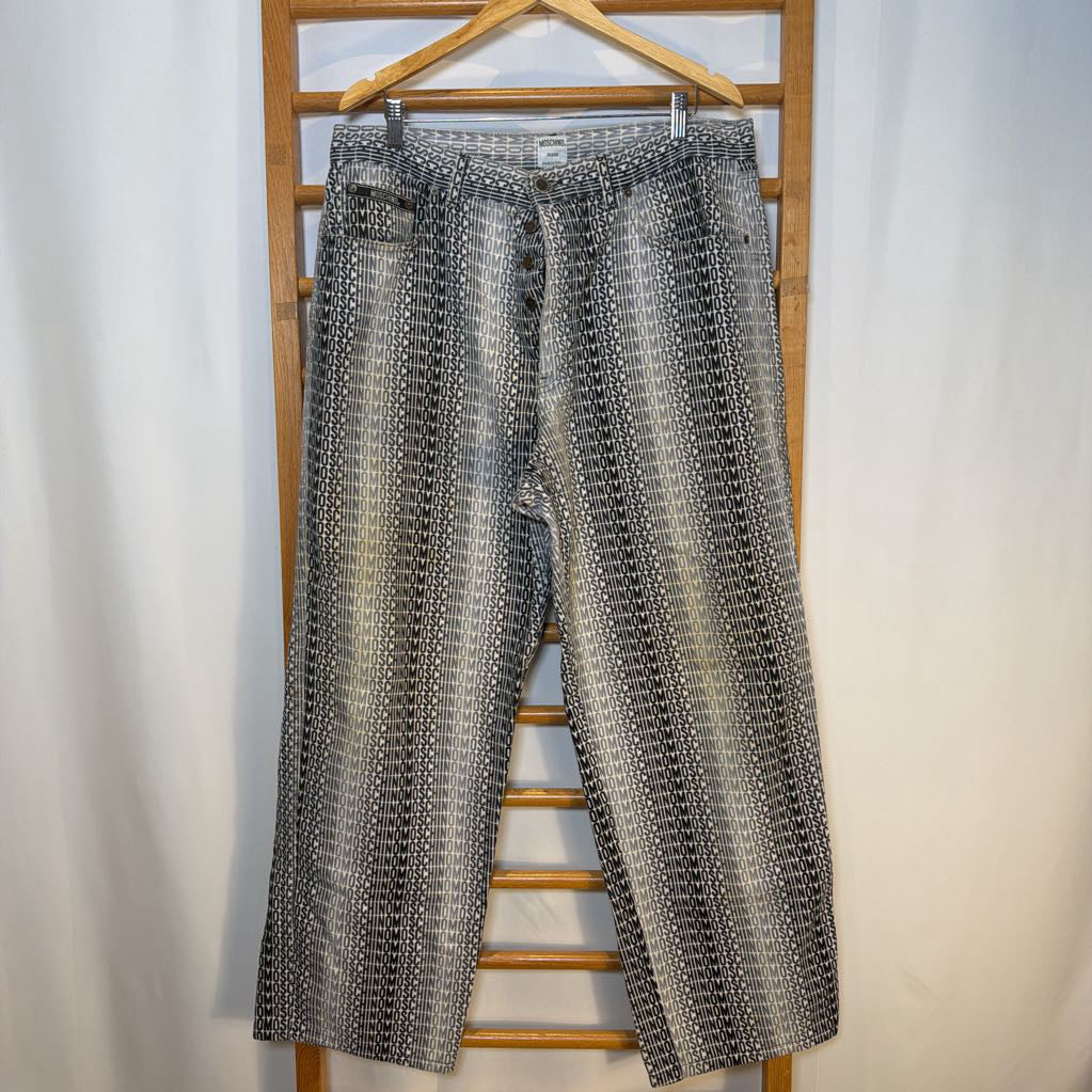 Patterned pants hanging on a wooden hanger against a white background