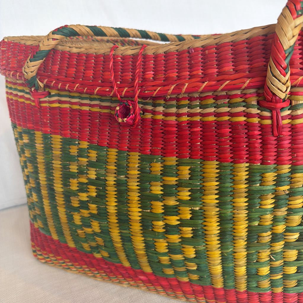 Colorful woven basket with a geometric pattern on a white background