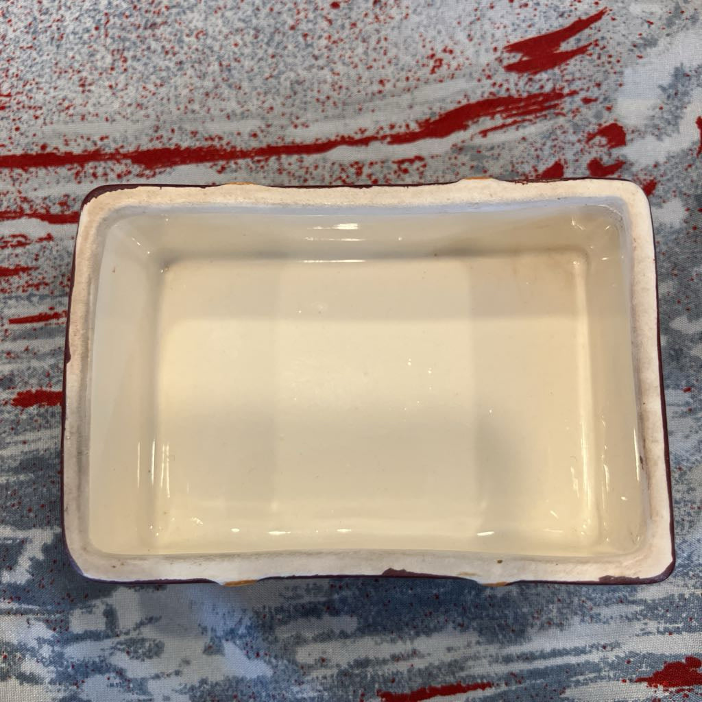 The inside of a ceramic dish on a colorful background.