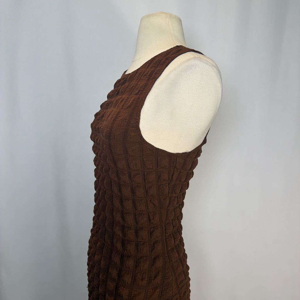 Brown textured dress on a mannequin against a plain background