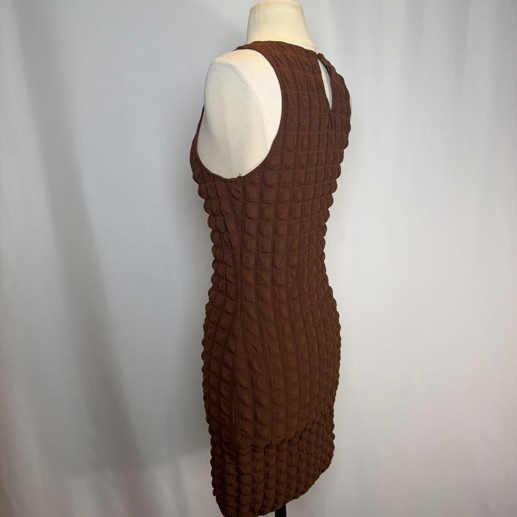 Brown textured dress on a mannequin against a plain background