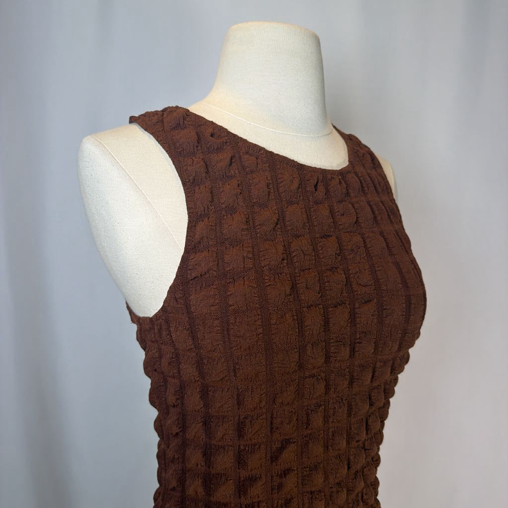 Brown textured dress on a mannequin against a plain background