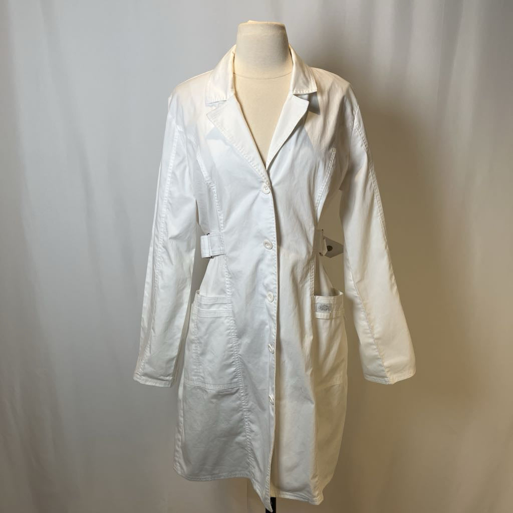 White lab coat on a mannequin against a plain background
