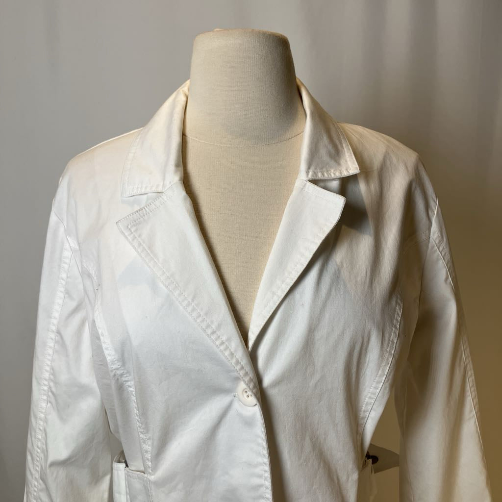 White lab coat on a mannequin against a plain background