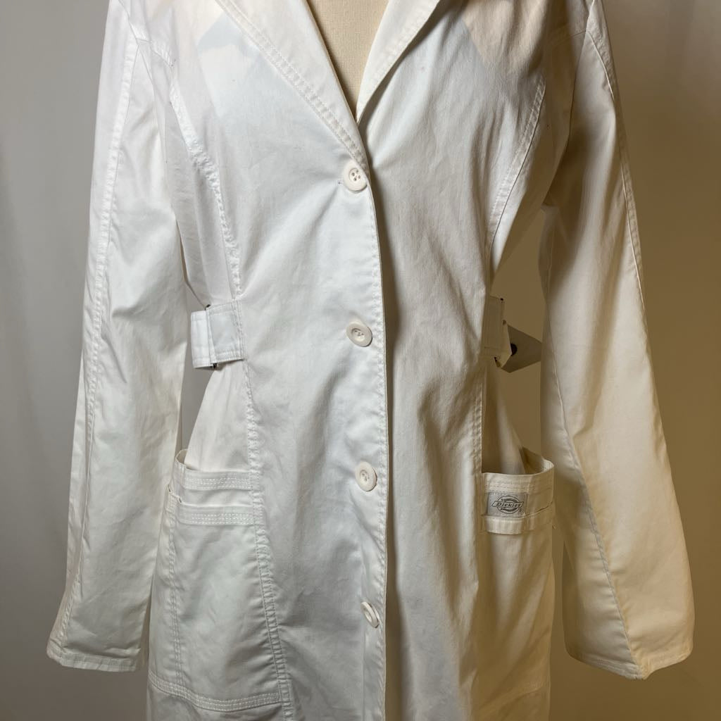 Light-colored lab coat on a mannequin against a plain background