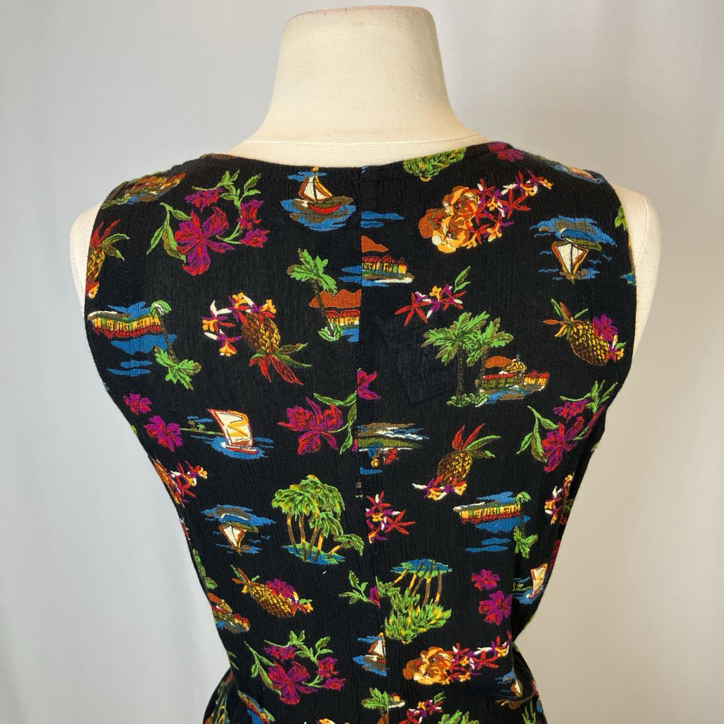 Mannequin wearing a black dress with colorful tropical pattern on a gray background