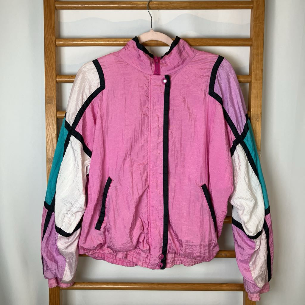 Pink jacket with white and teal accents on a wooden rack