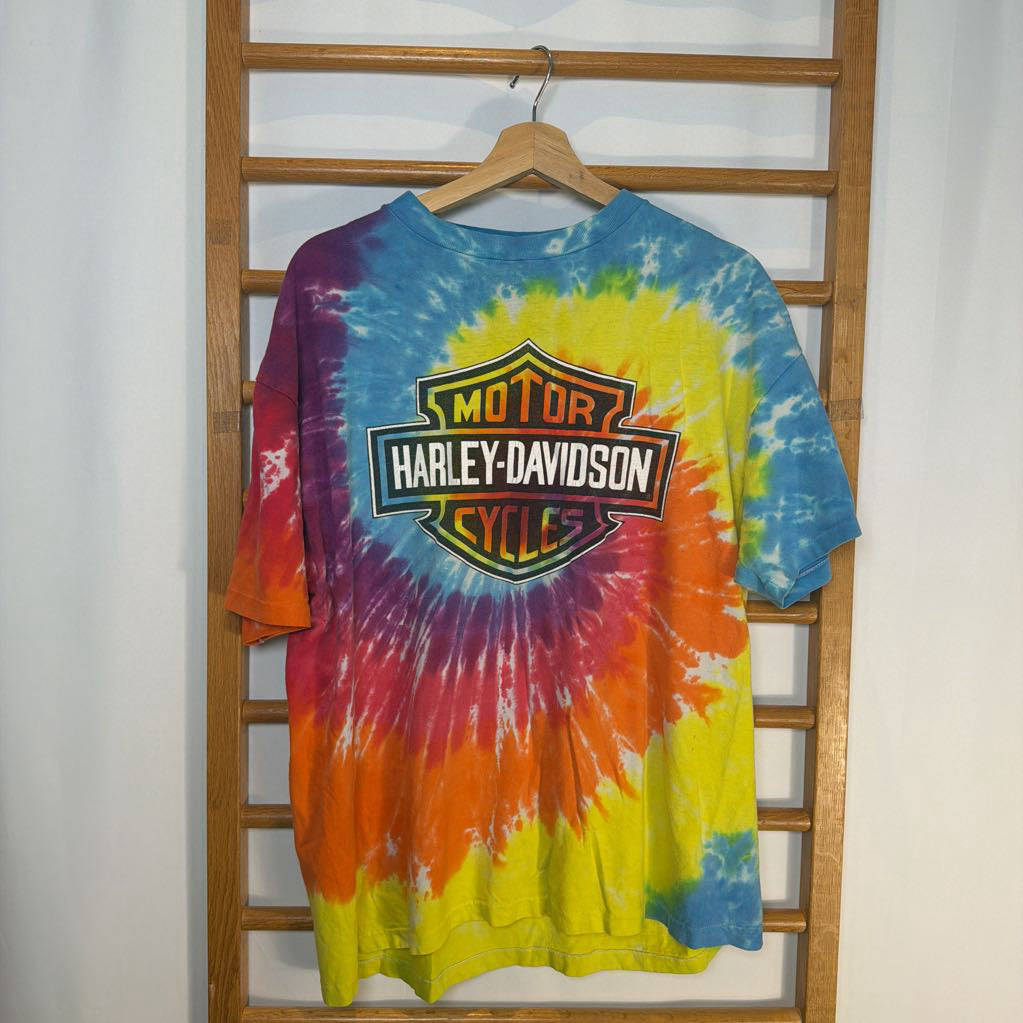 Tie-dye Harley-Davidson t-shirt on a wooden hanger against a white background