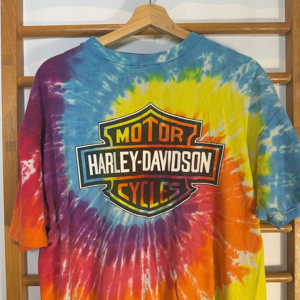 Tie-dye long-sleeve shirt with Harley-Davidson logo on a wooden hanger.