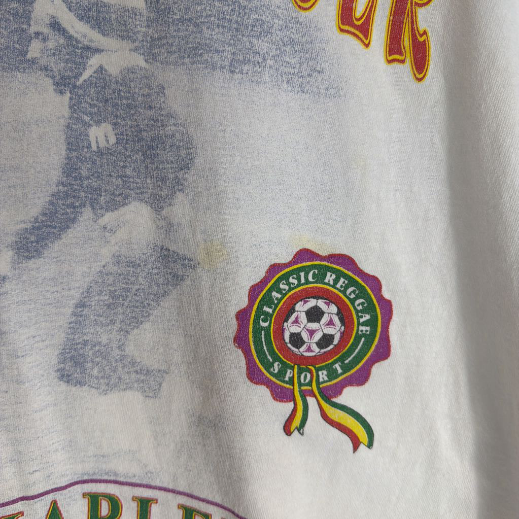 Close-up of a shirt with a logo and text, featuring a soccer ball design.