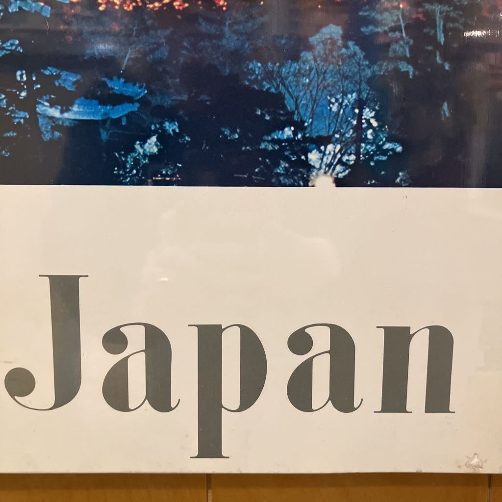 Text 'Japan' on a white background with a blurred scenic image in the background.