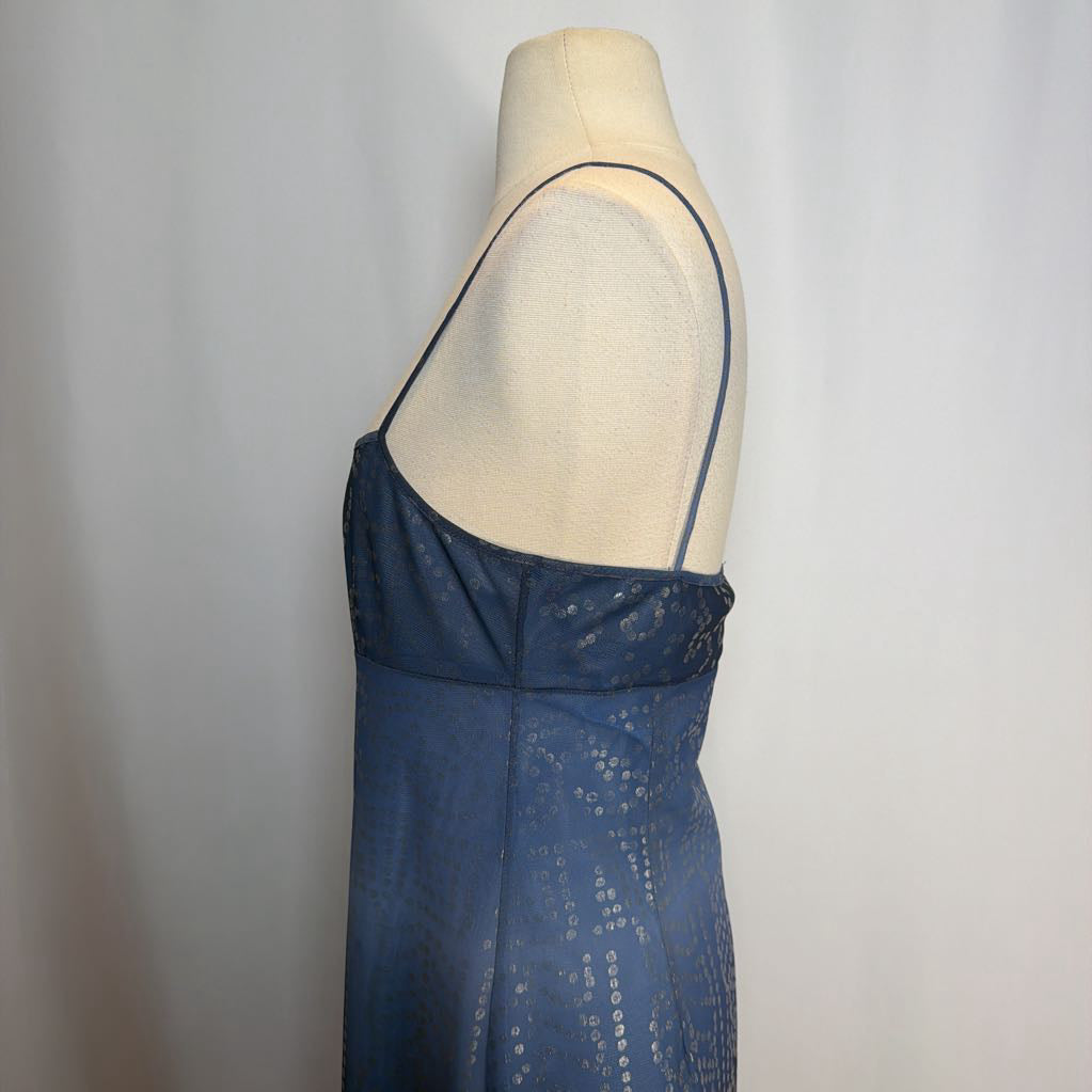Blue dress on a mannequin against a plain background