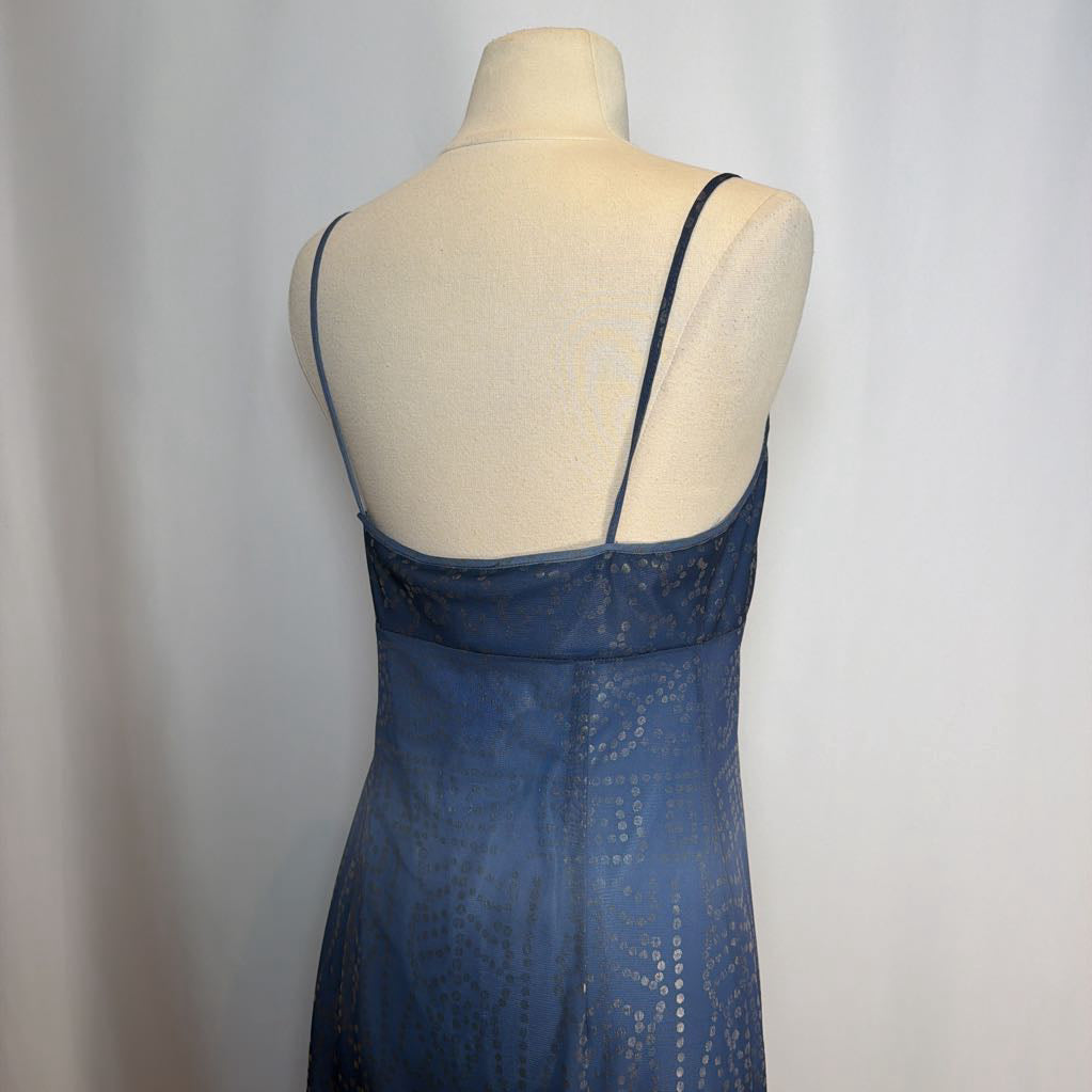 Blue dress on a mannequin against a plain background