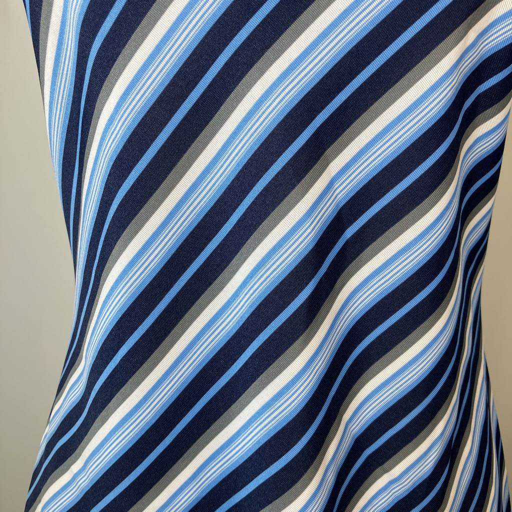 Close-up of a fabric with blue, white, and gray stripes on a neutral background
