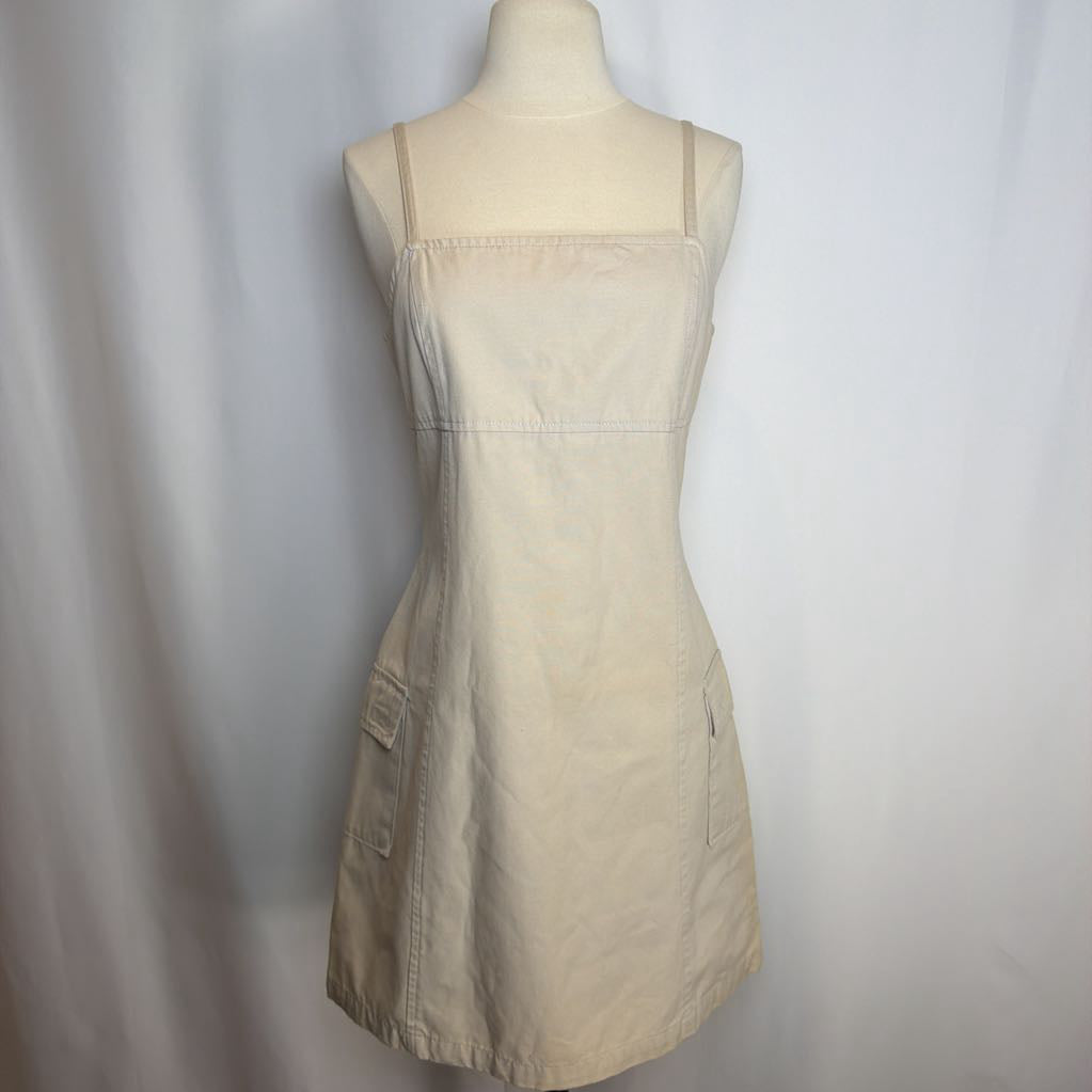 Beige dress on a mannequin against a white background