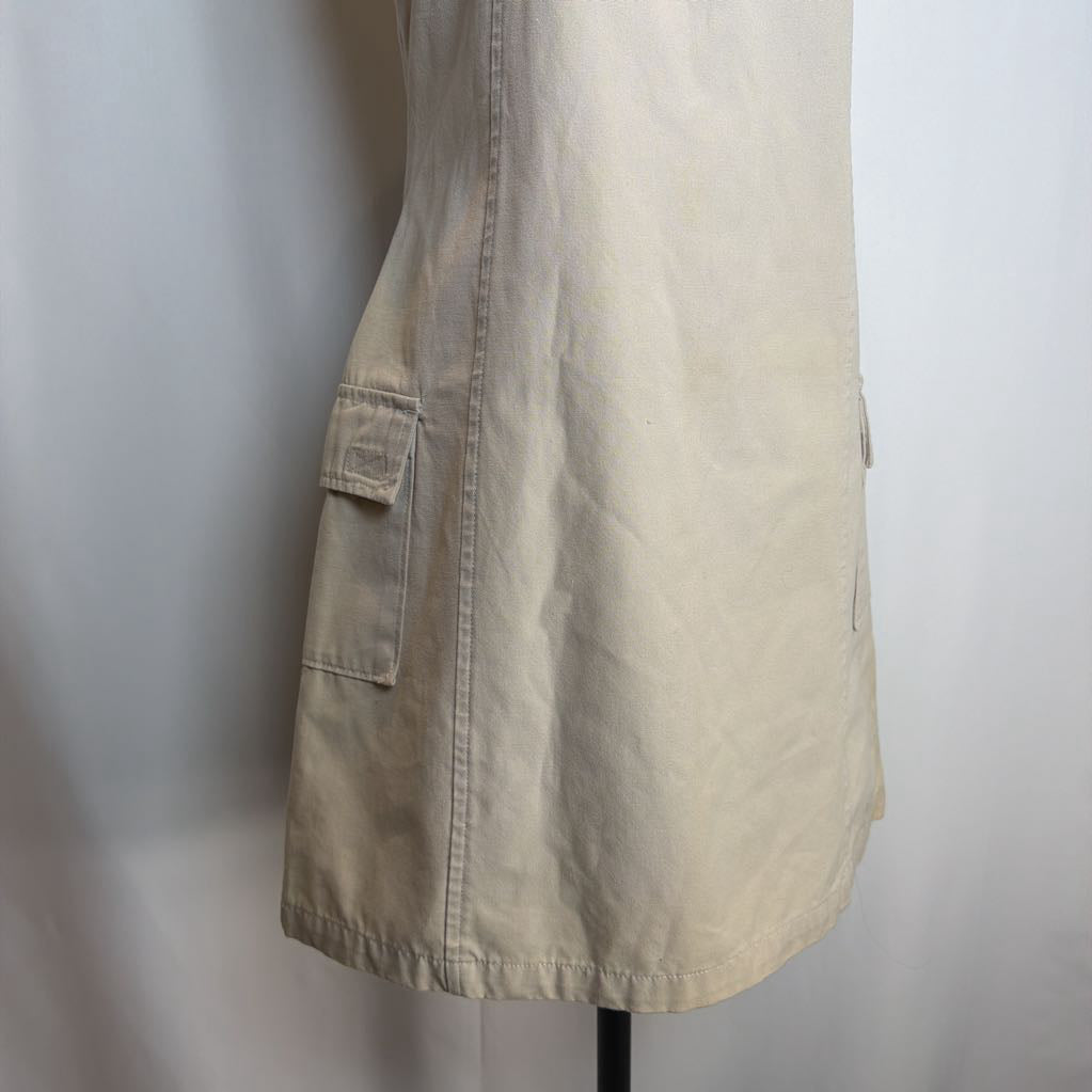 Beige dress on a mannequin against a plain background