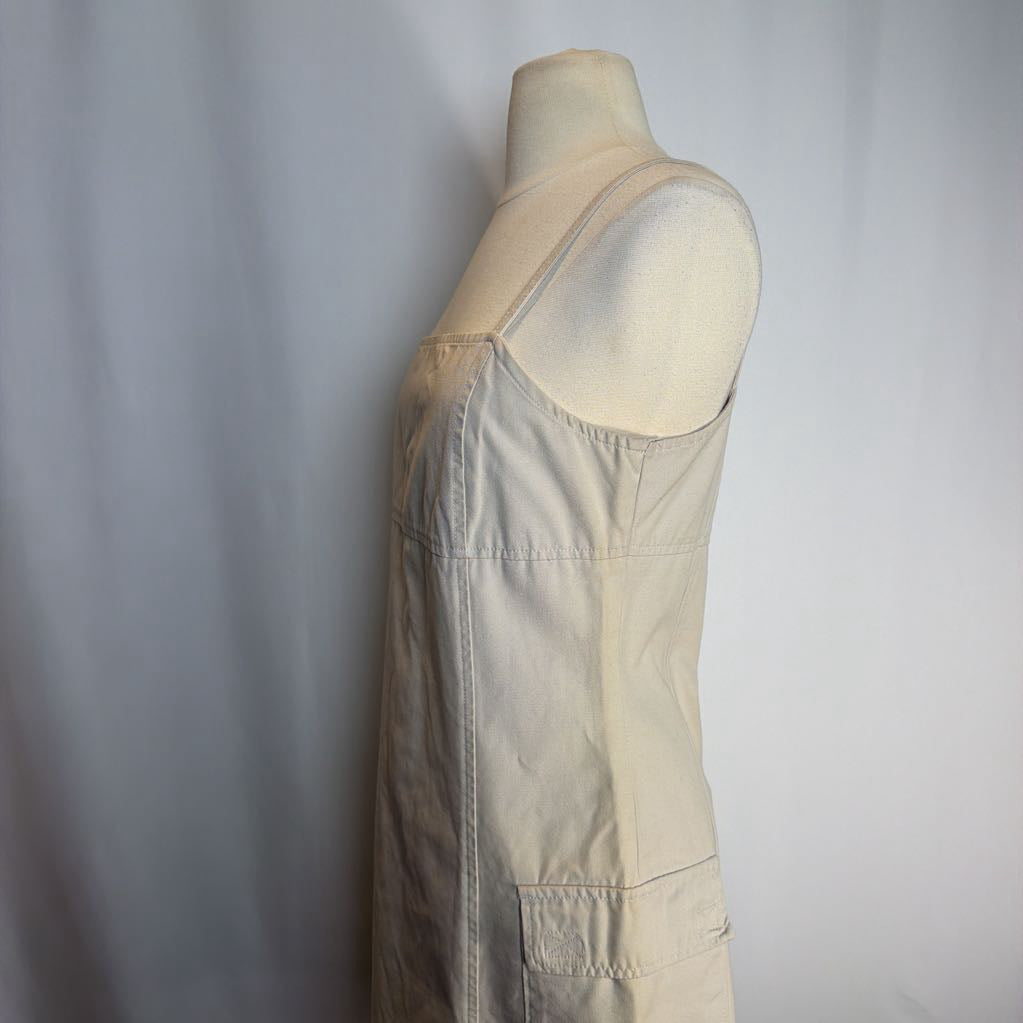 Beige dress on a mannequin against a plain background