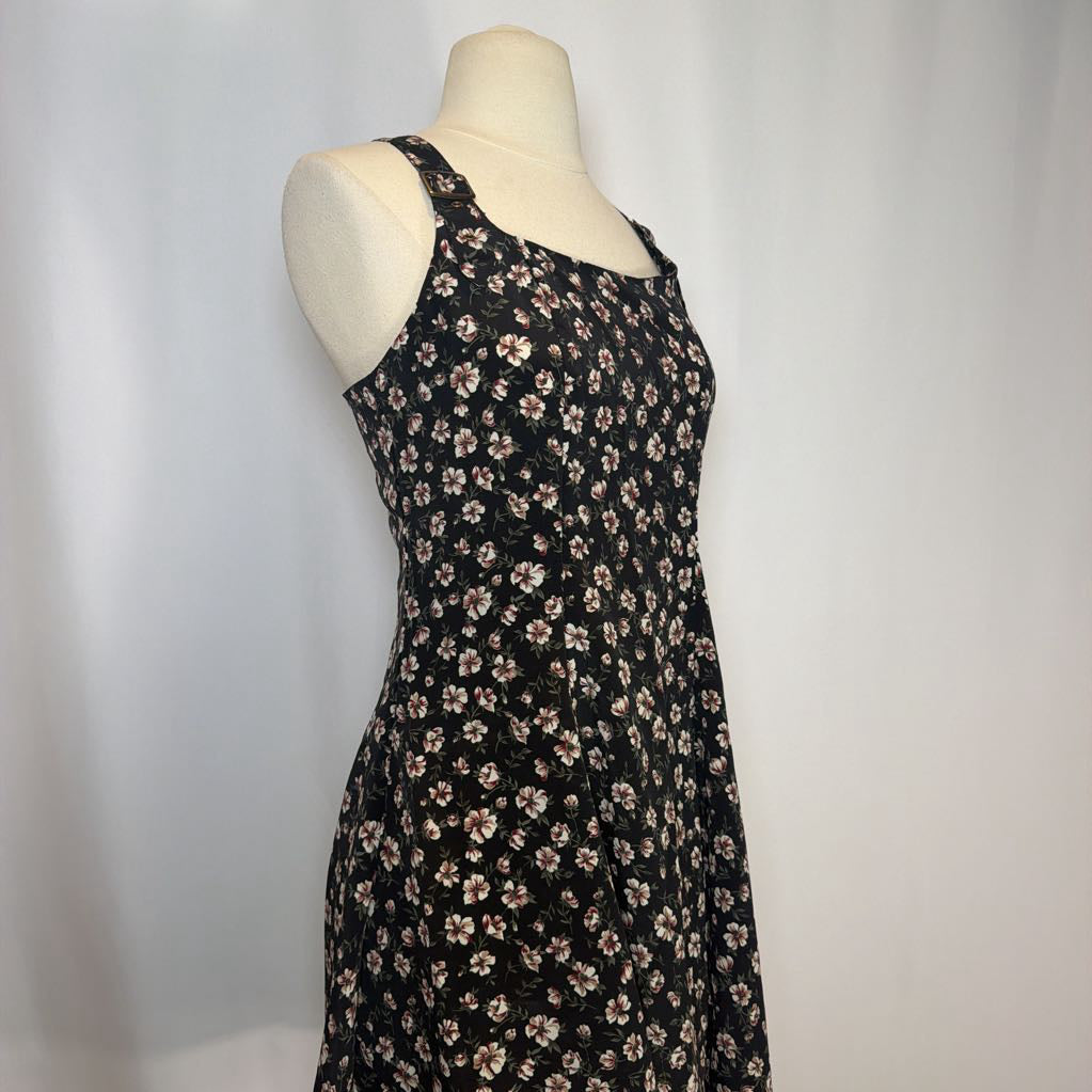 Black floral dress on a mannequin against a white background