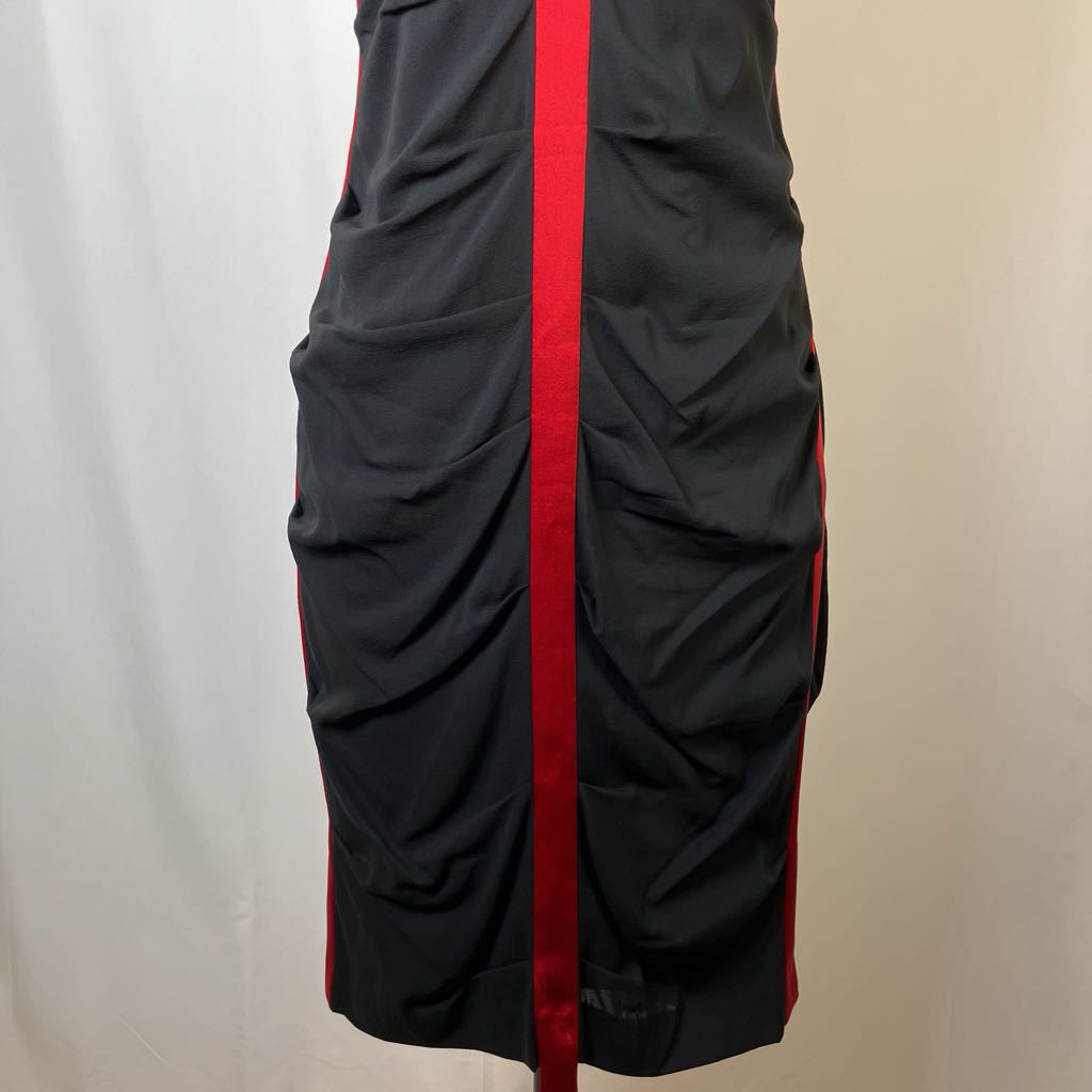 Black dress with a red stripe on a neutral background