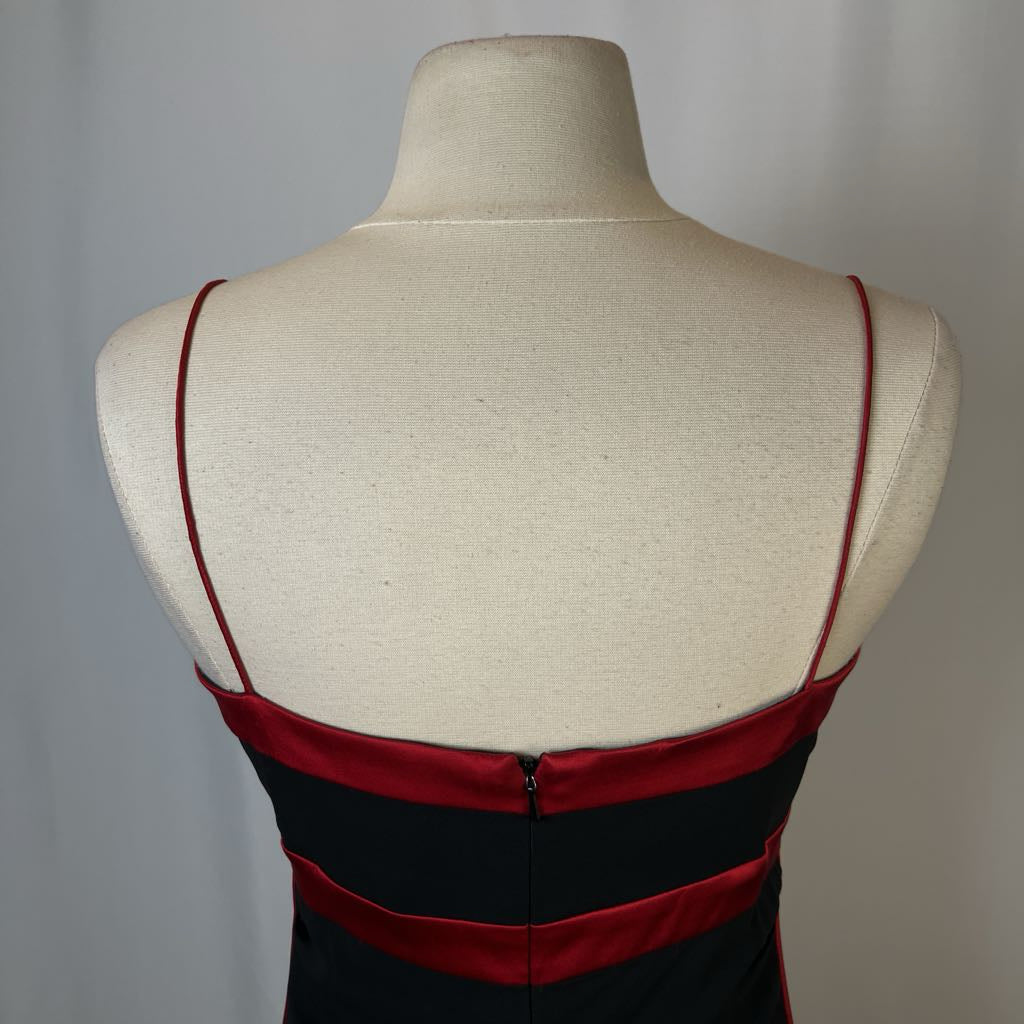 Red and black dress on a mannequin with a plain background