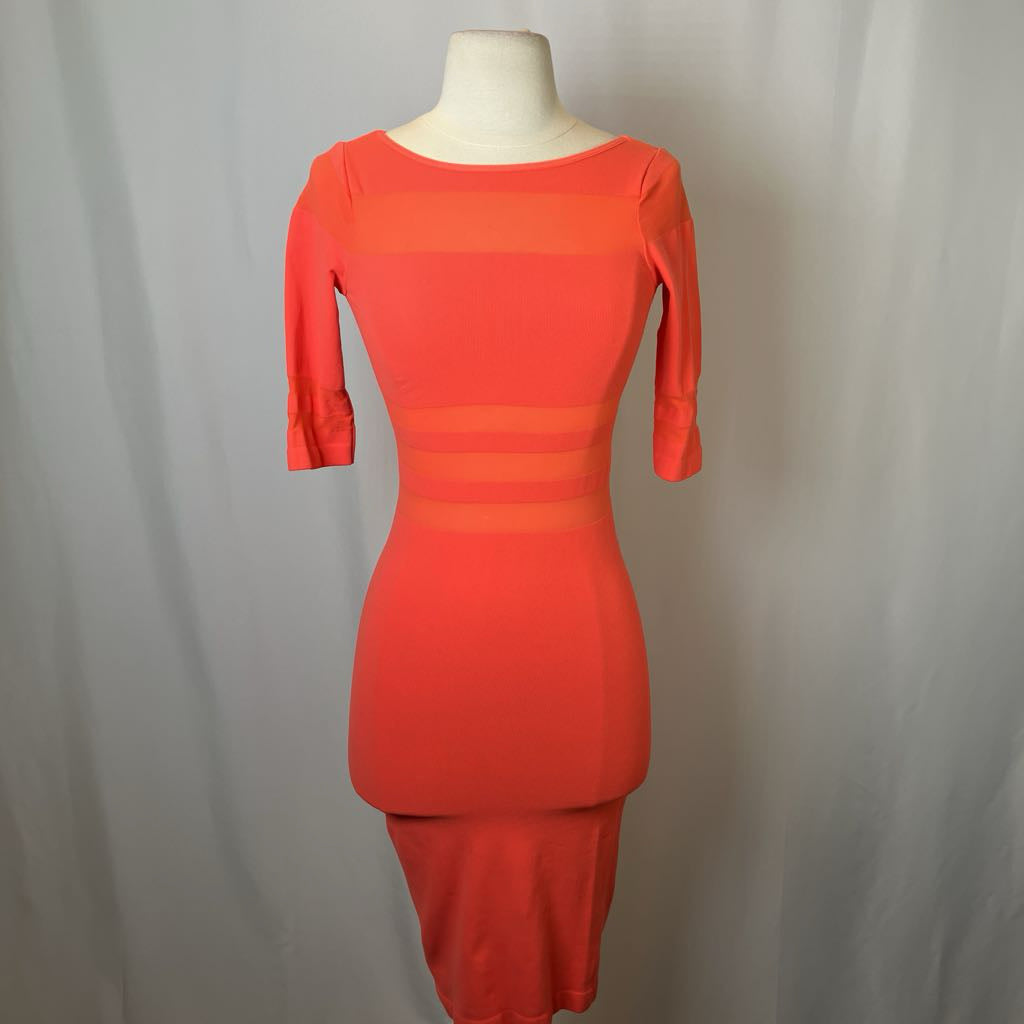 Orange dress on a mannequin against a plain background