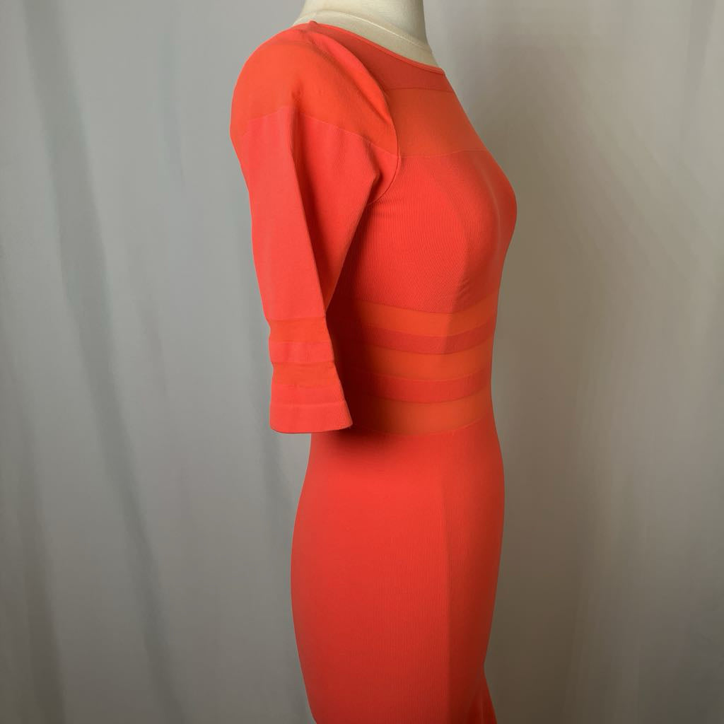 Red dress on a mannequin against a plain background