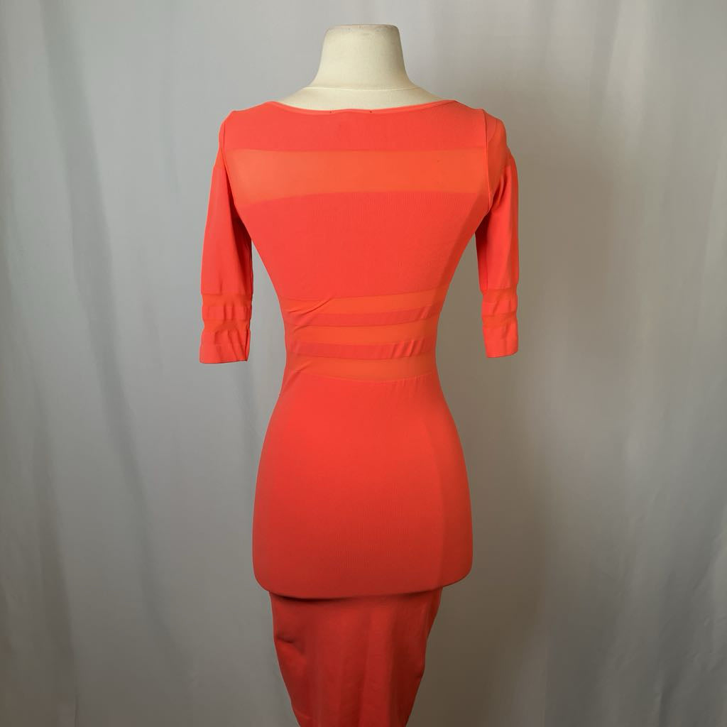 Orange dress on a mannequin against a plain background
