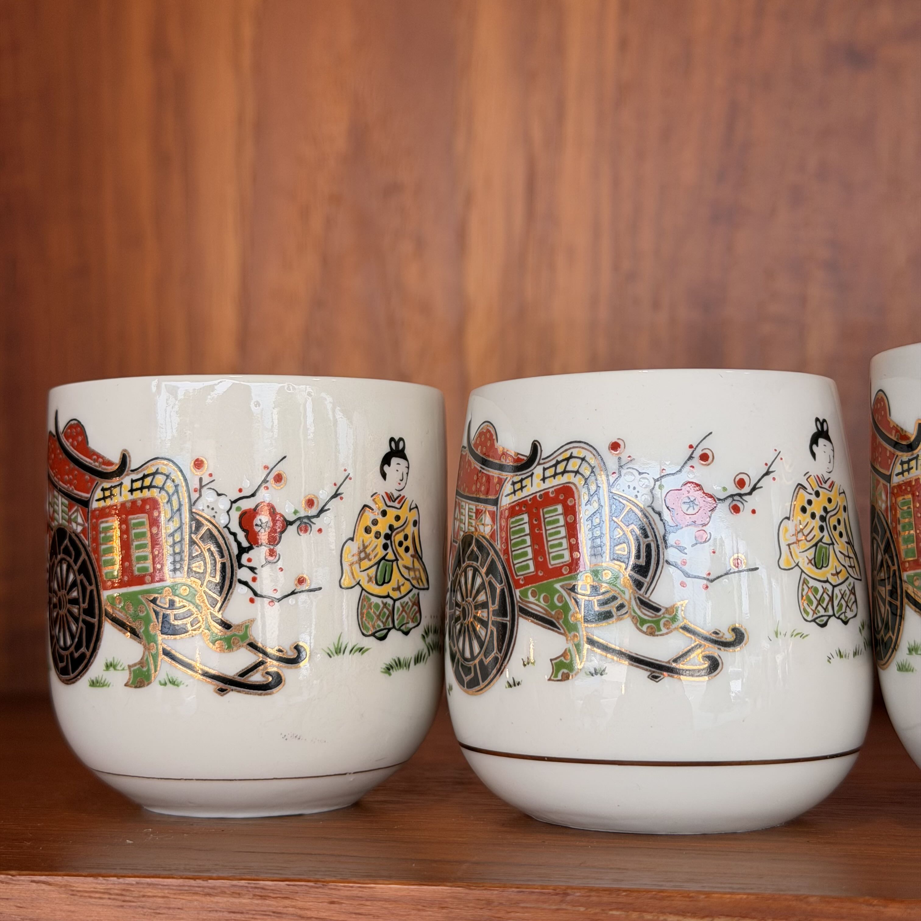 close up of Vintage Japanese Tea Ceremony Cups against a wooden background