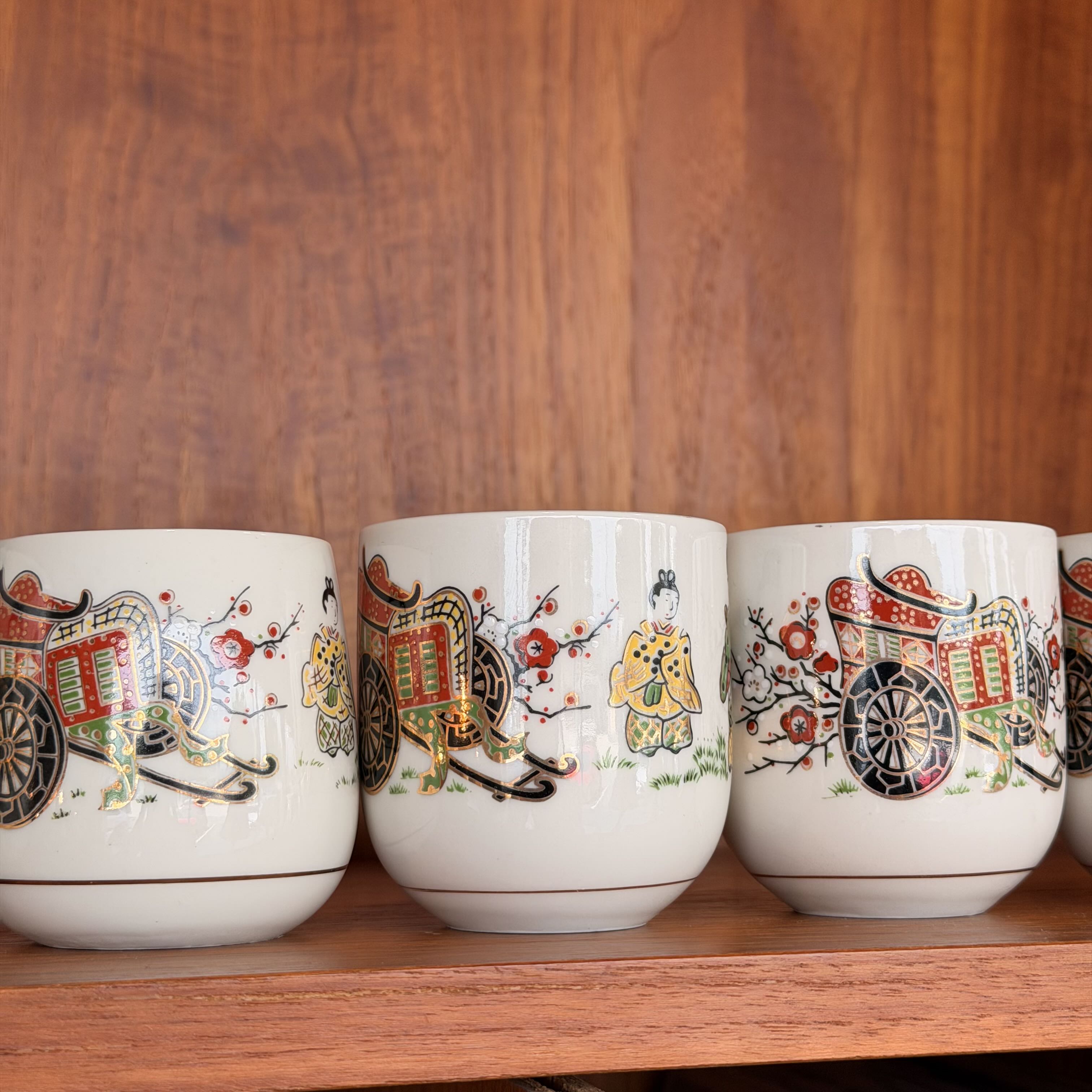 close up of Vintage Japanese Tea Ceremony Cups against a wooden background