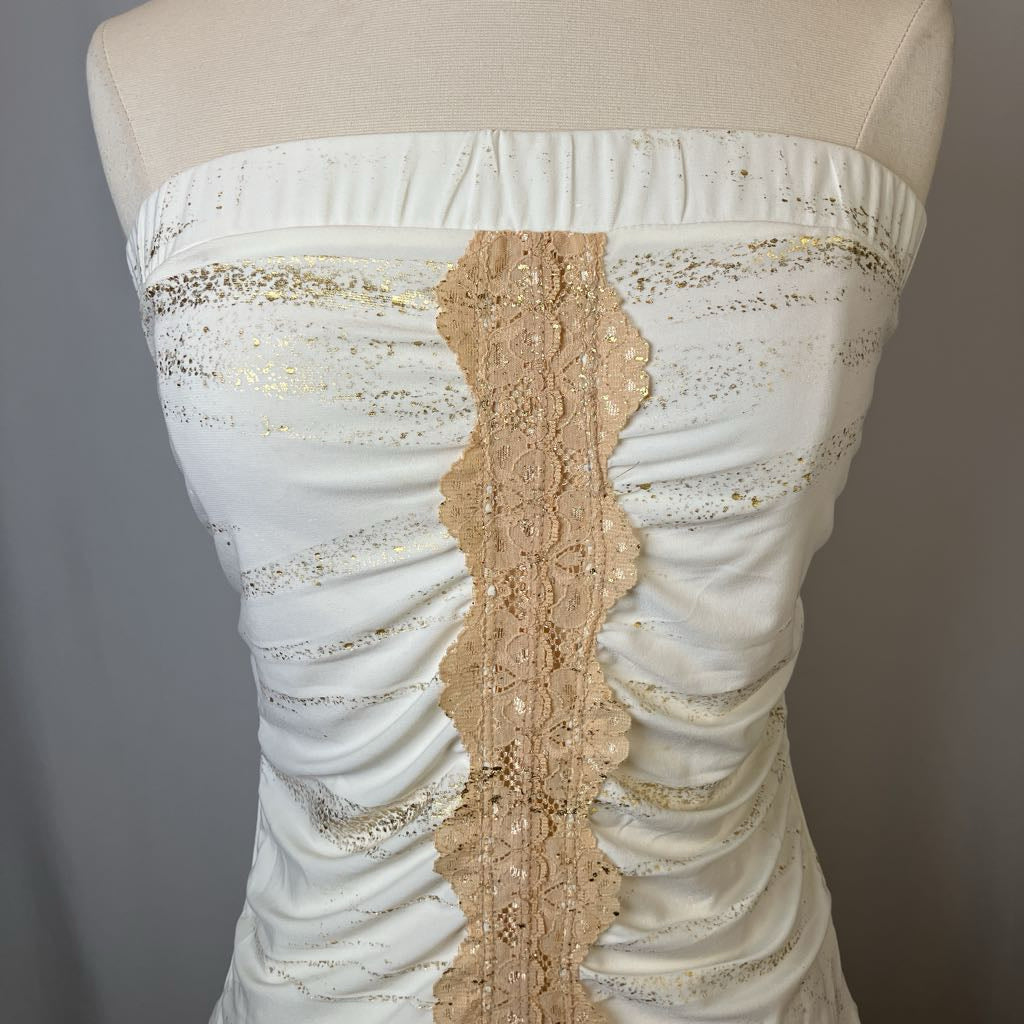 White strapless top with gold lace detailing on a mannequin against a gray background