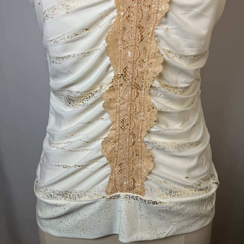 White textured fabric with gold lace trim on a mannequin against a gray background