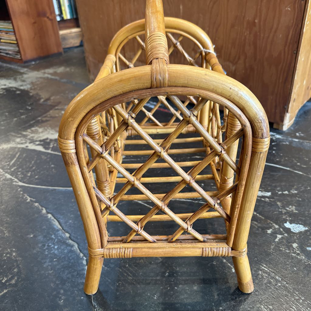 Wicker chair on a dark floor with a wooden cabinet in the background