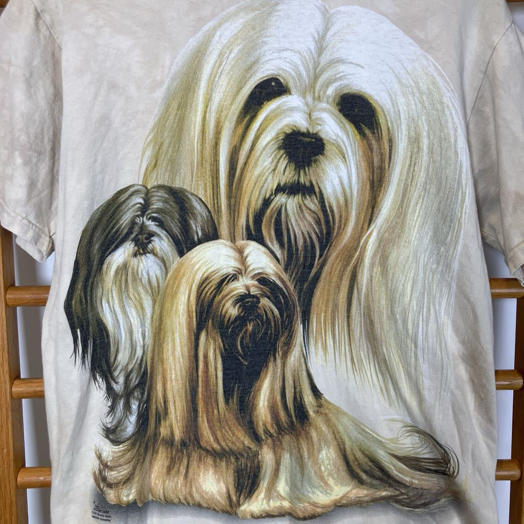 T-shirt with a graphic of three dogs on a wooden rack.