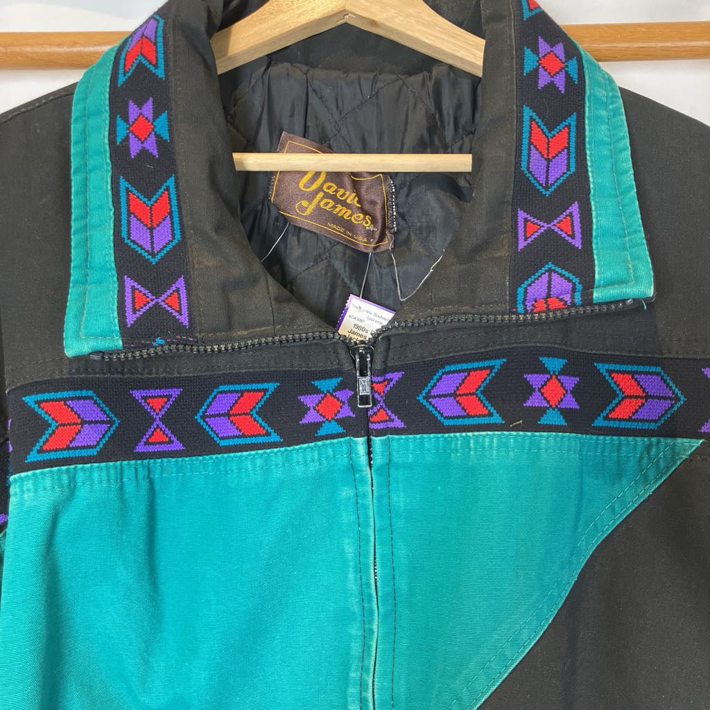 Teal and black jacket with colorful patterns on a hanger