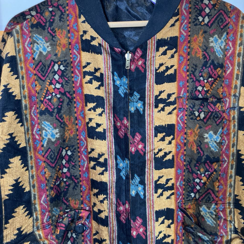 Colorful patterned jacket with a hanger on a light blue background