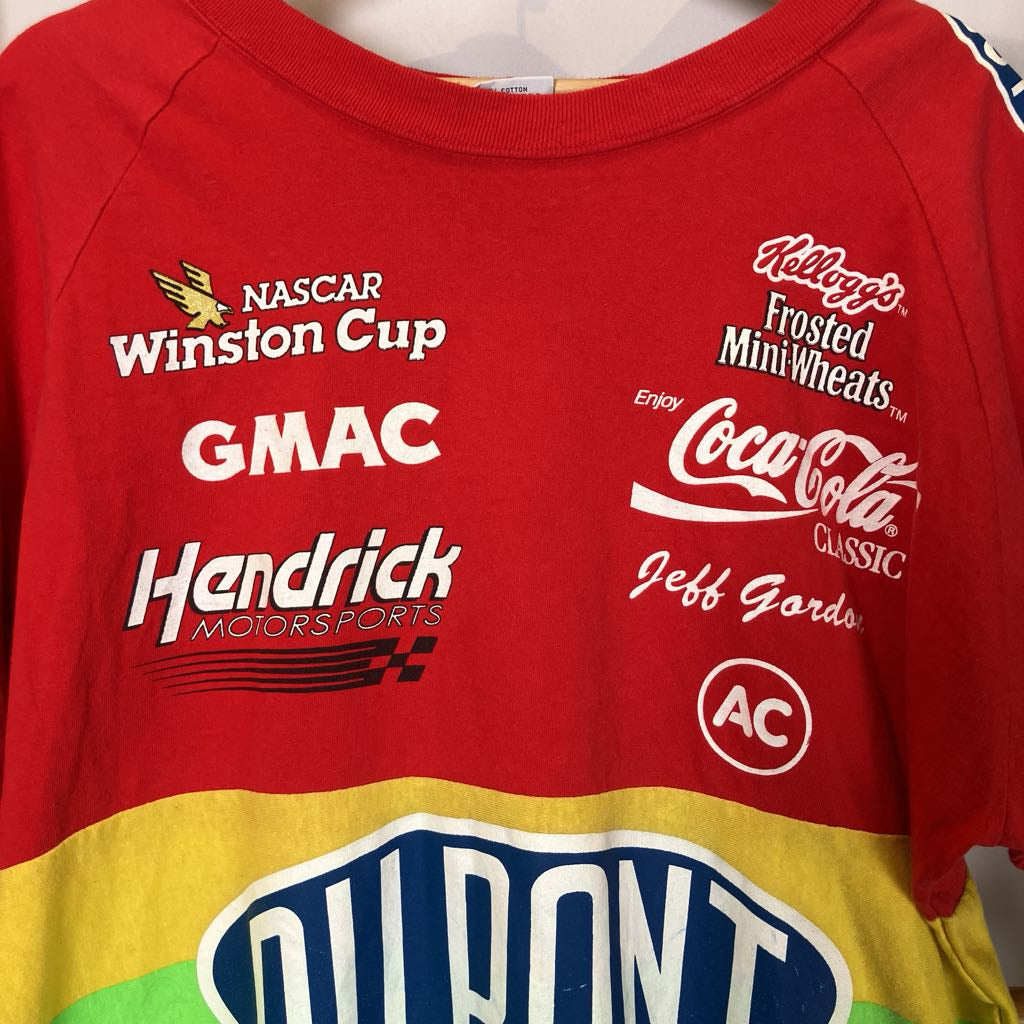 Red shirt with various sponsor logos including NASCAR, Winston Cup, and Coca-Cola.