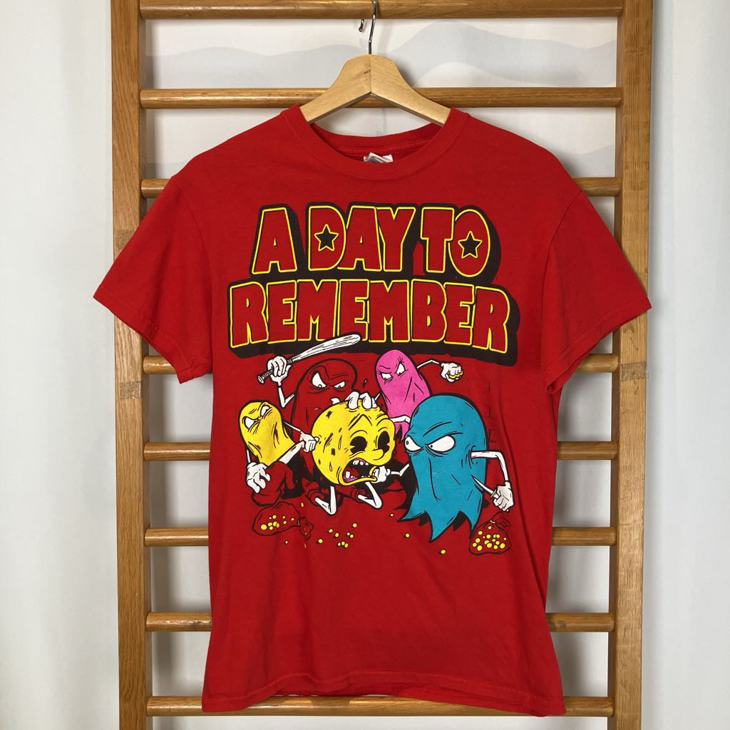 Red graphic tee on a white background. 