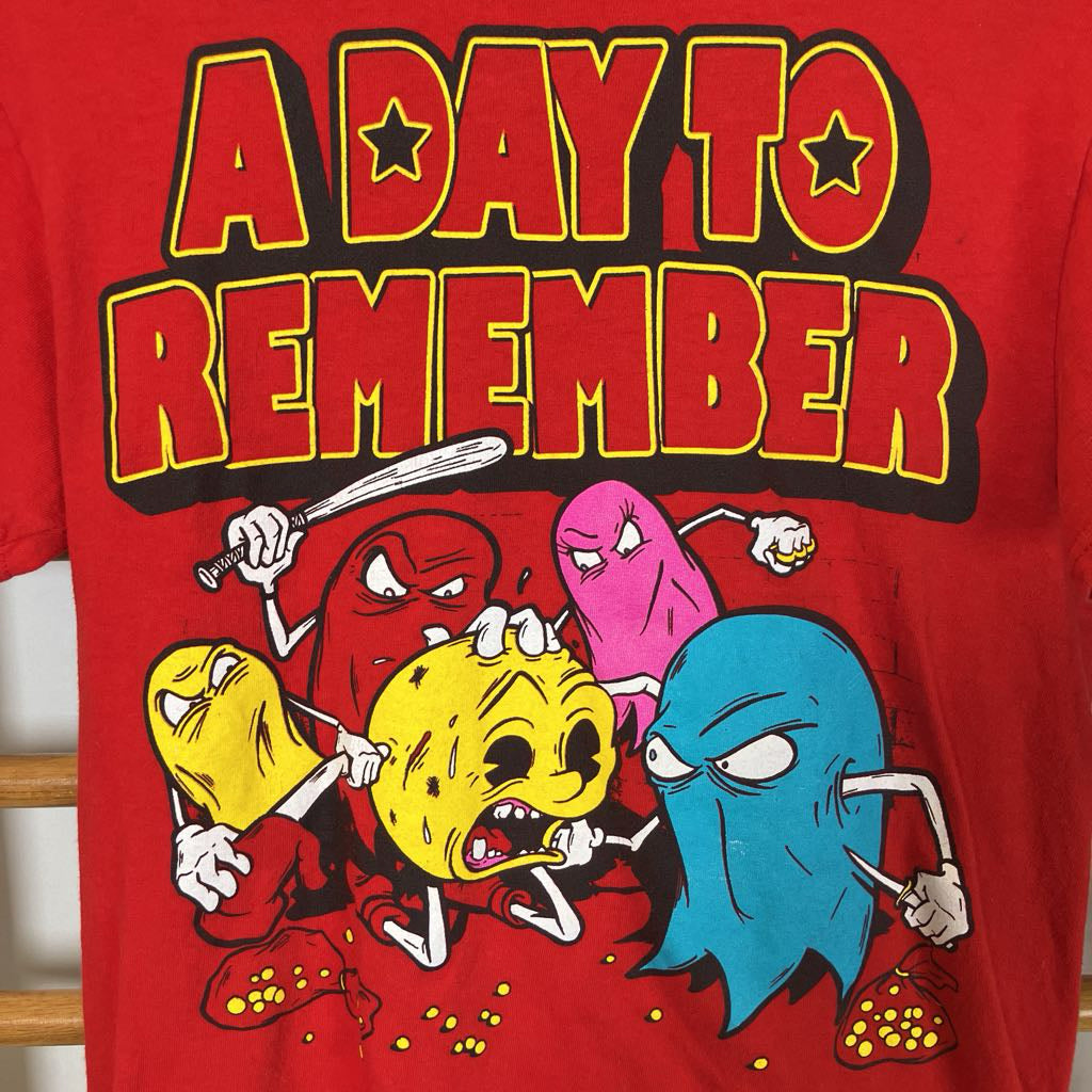 Red graphic tee on a white background. 