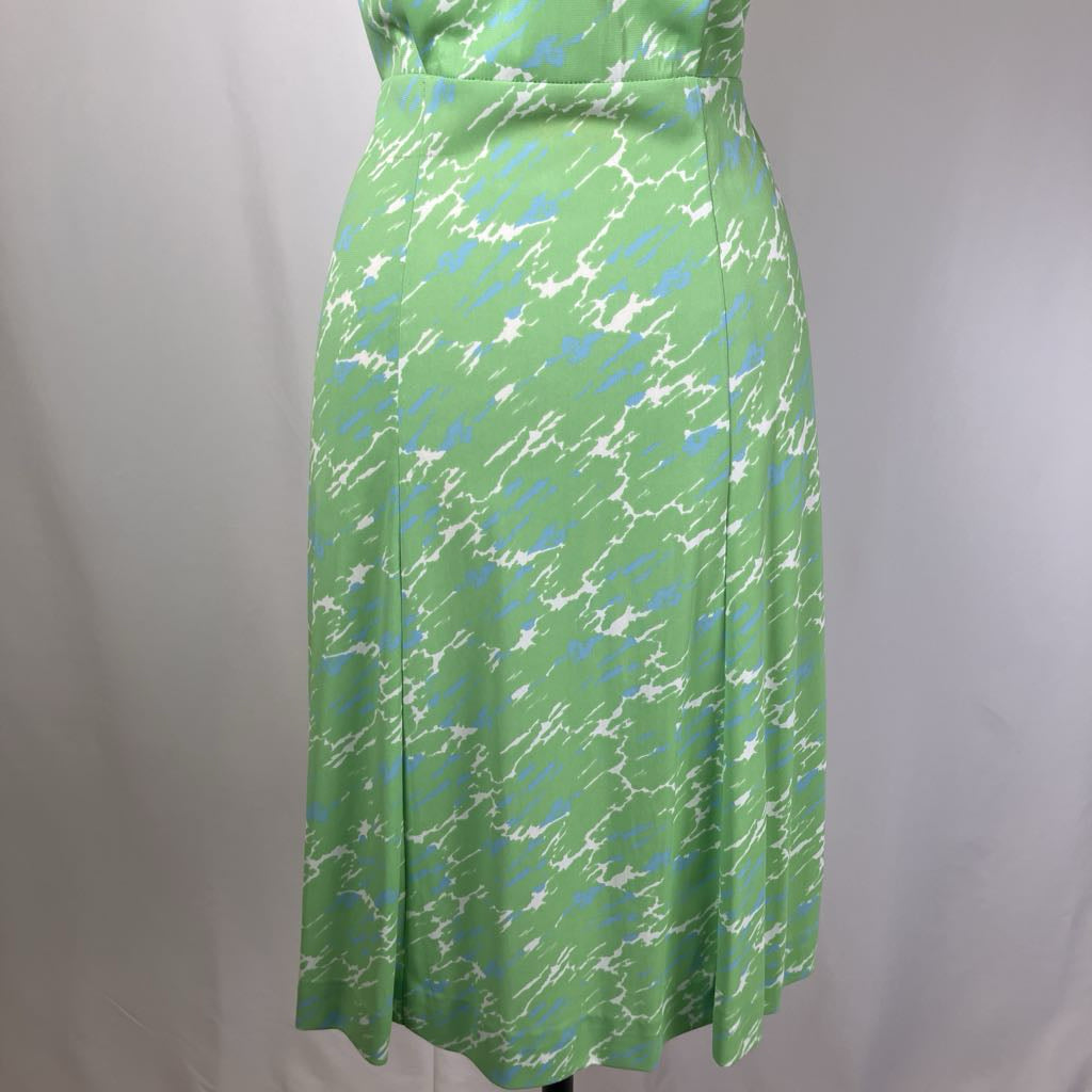 Green dress with abstract pattern on a plain background