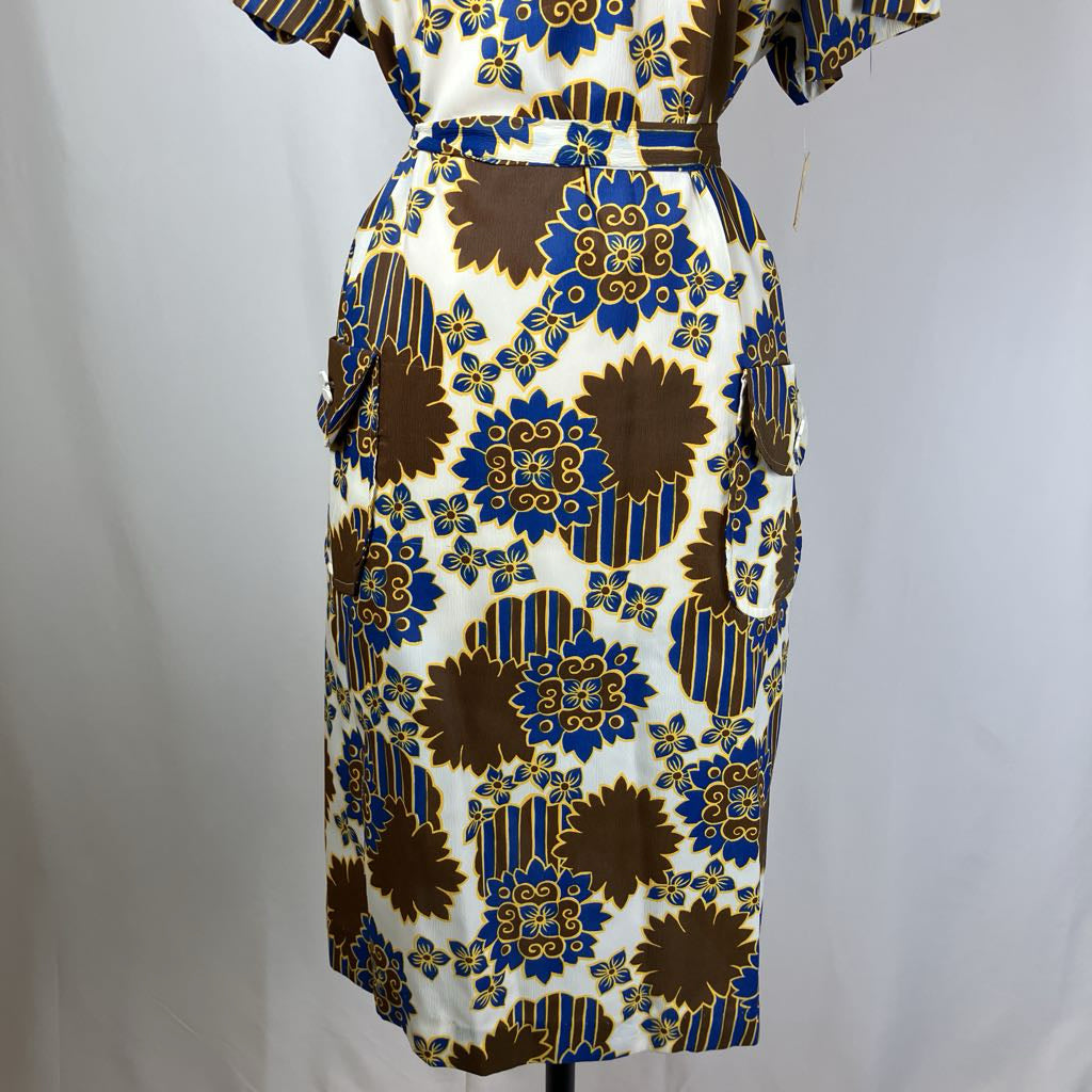 Patterned dress on a mannequin against a plain background