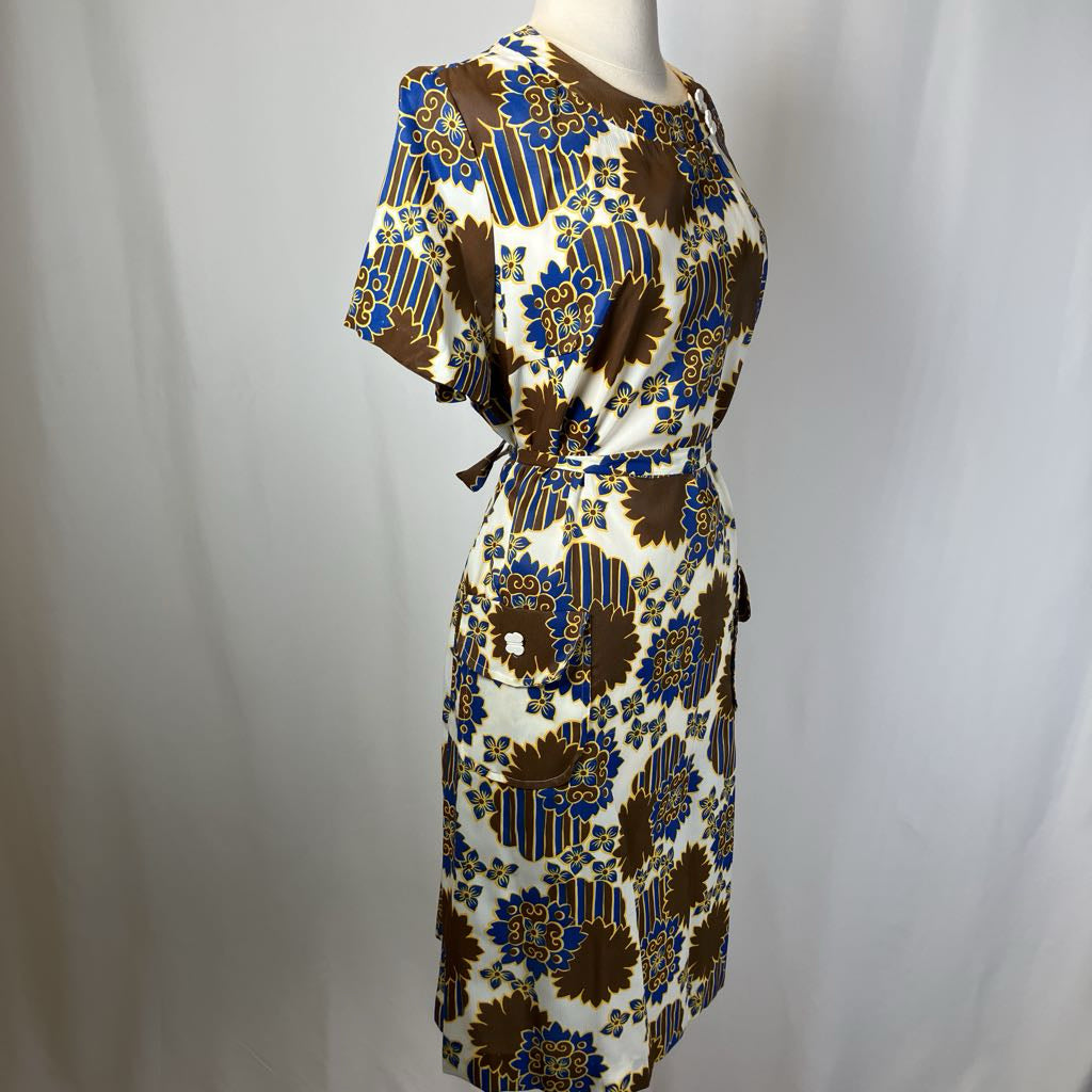 Patterned dress on a mannequin against a plain background