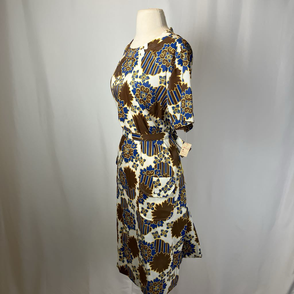Patterned dress on a mannequin against a plain background