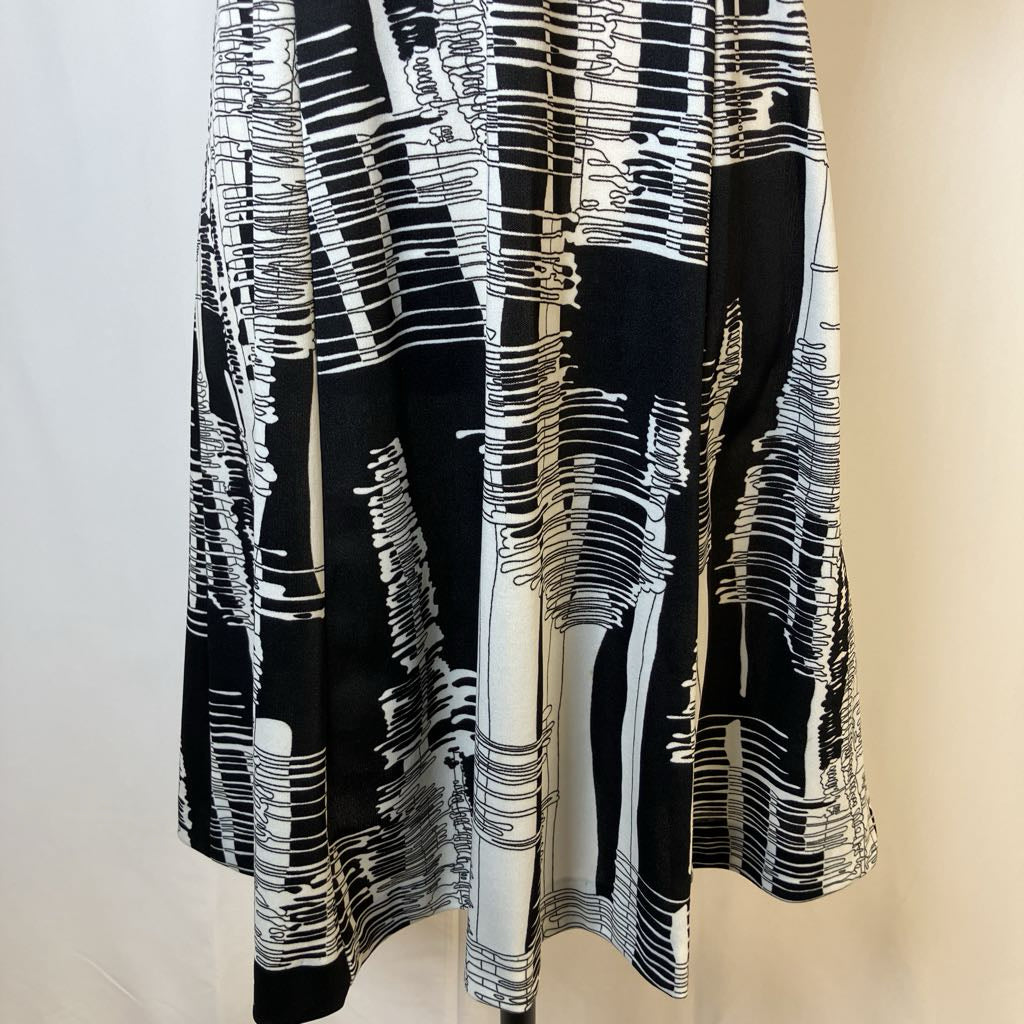 Black and white patterned dress on a mannequin against a neutral background