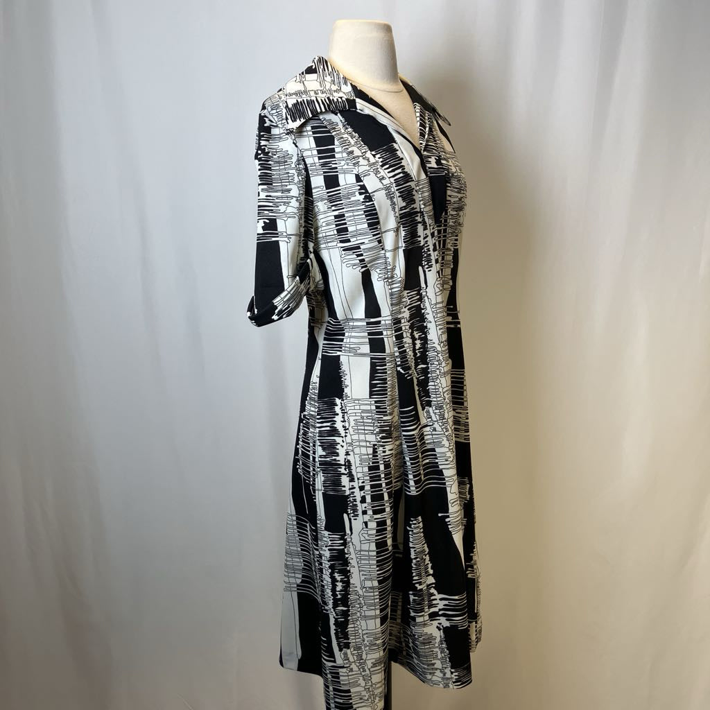 Black and white patterned dress on a mannequin against a plain background