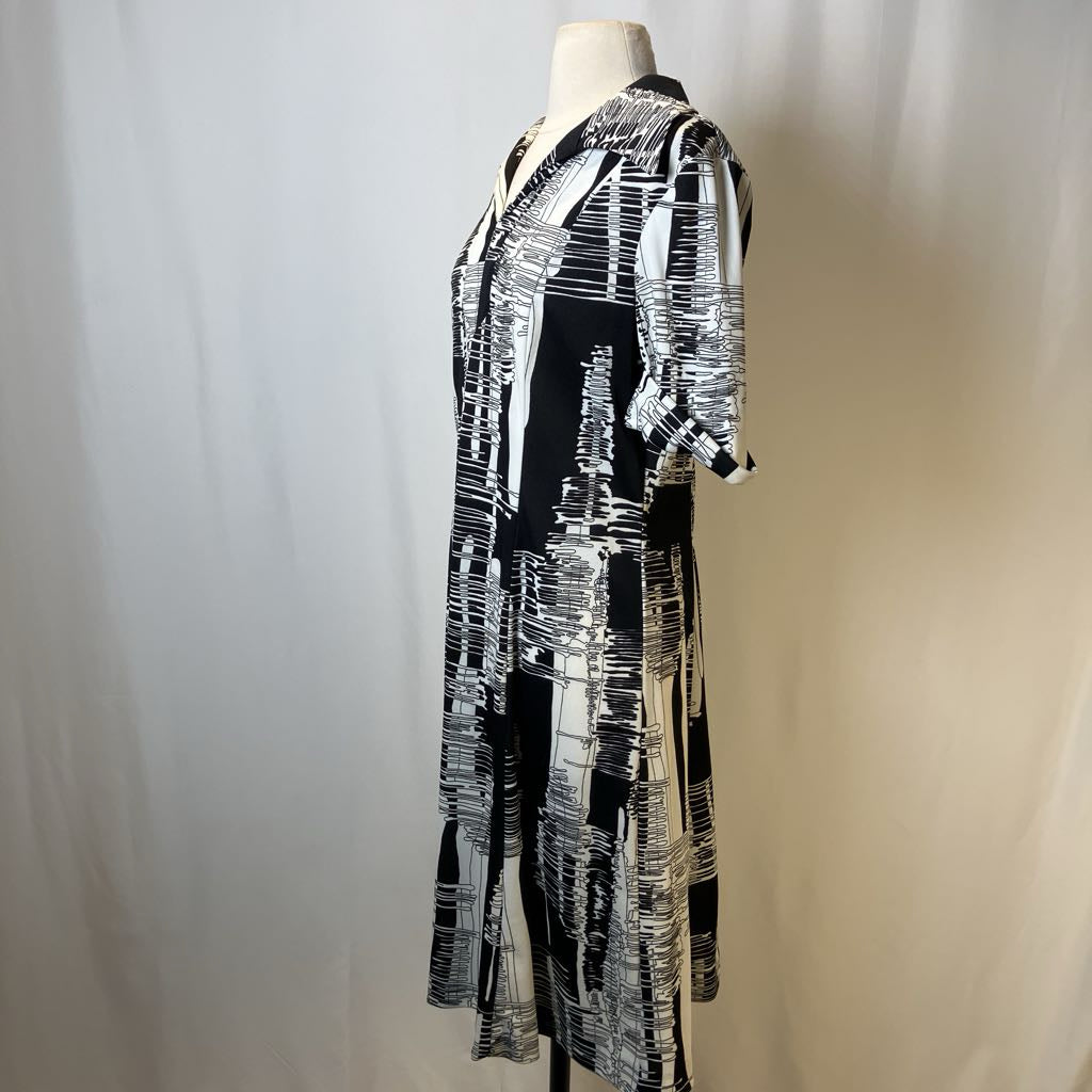 Black and white patterned dress on a mannequin against a plain background