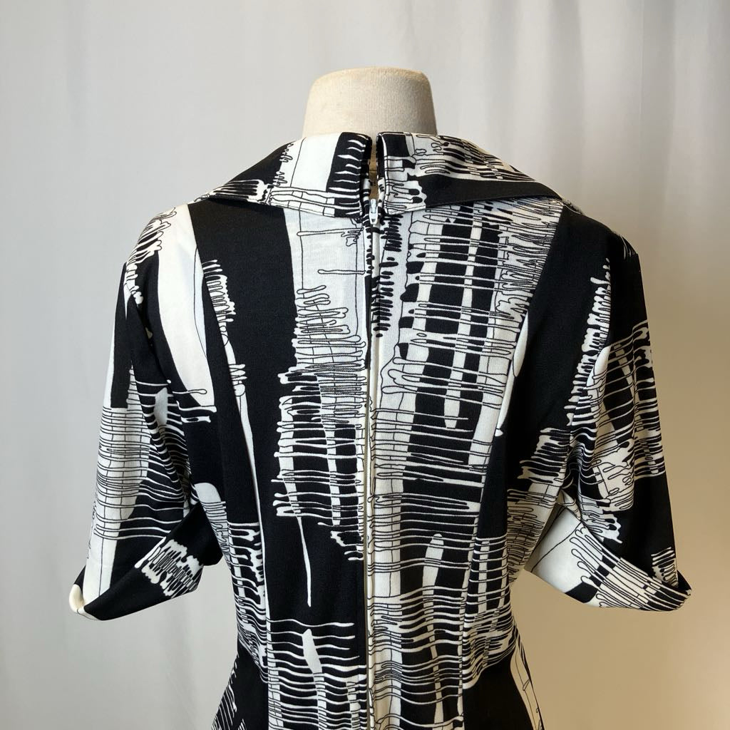 Black and white patterned shirt on a mannequin against a neutral background