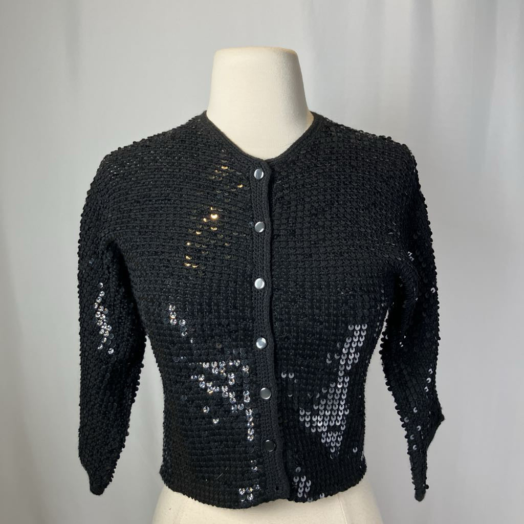 Black sequined jacket on a mannequin against a plain background