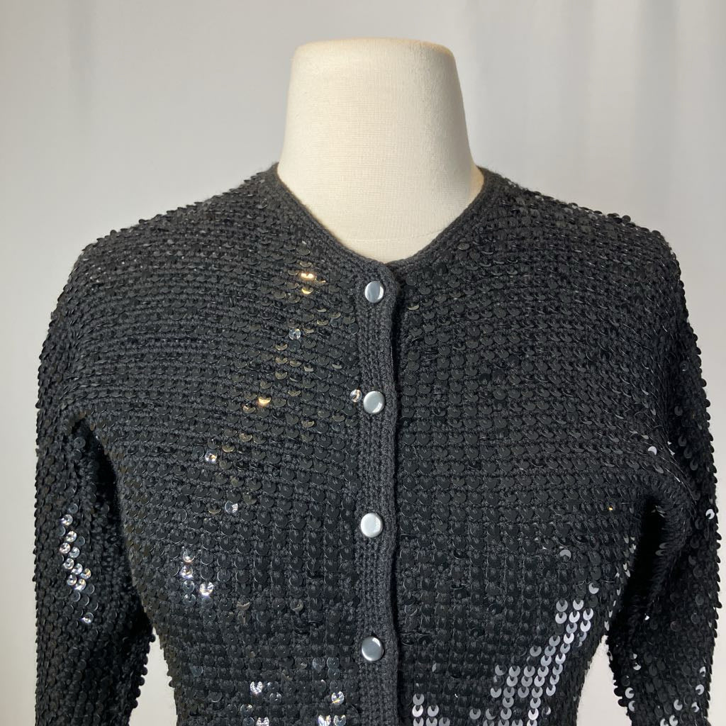 Black sequined jacket on a mannequin against a plain background