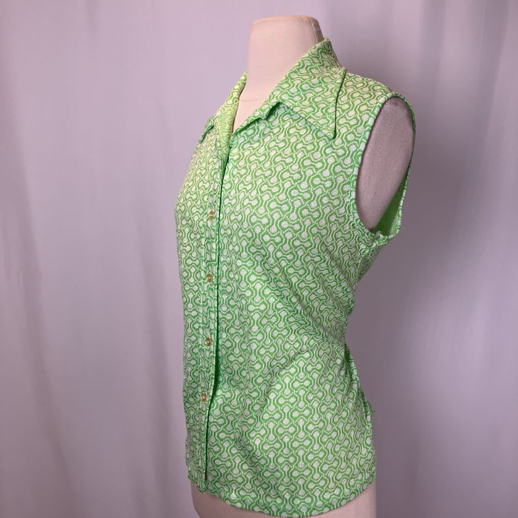 Green patterned sleeveless blouse on a mannequin against a plain background